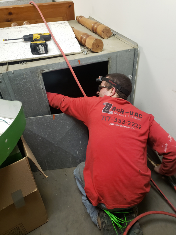 man in red performing an HVAC Duct Cleaning in Reading