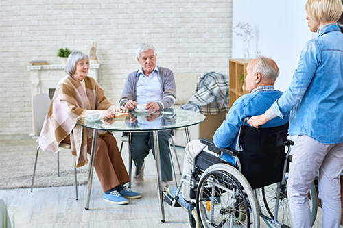 Elderly People Sitting Around Table in a Facility After Air Duct Cleaning in Mount Joy, PA