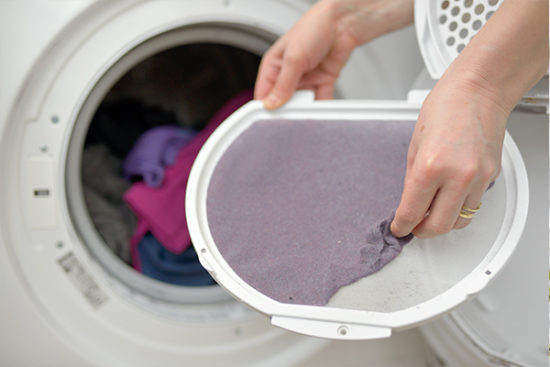 Hands Holding Dryer Pan from Laundry Machine Before Dryer Vent Cleaning in Palmyra, Pennsylvania